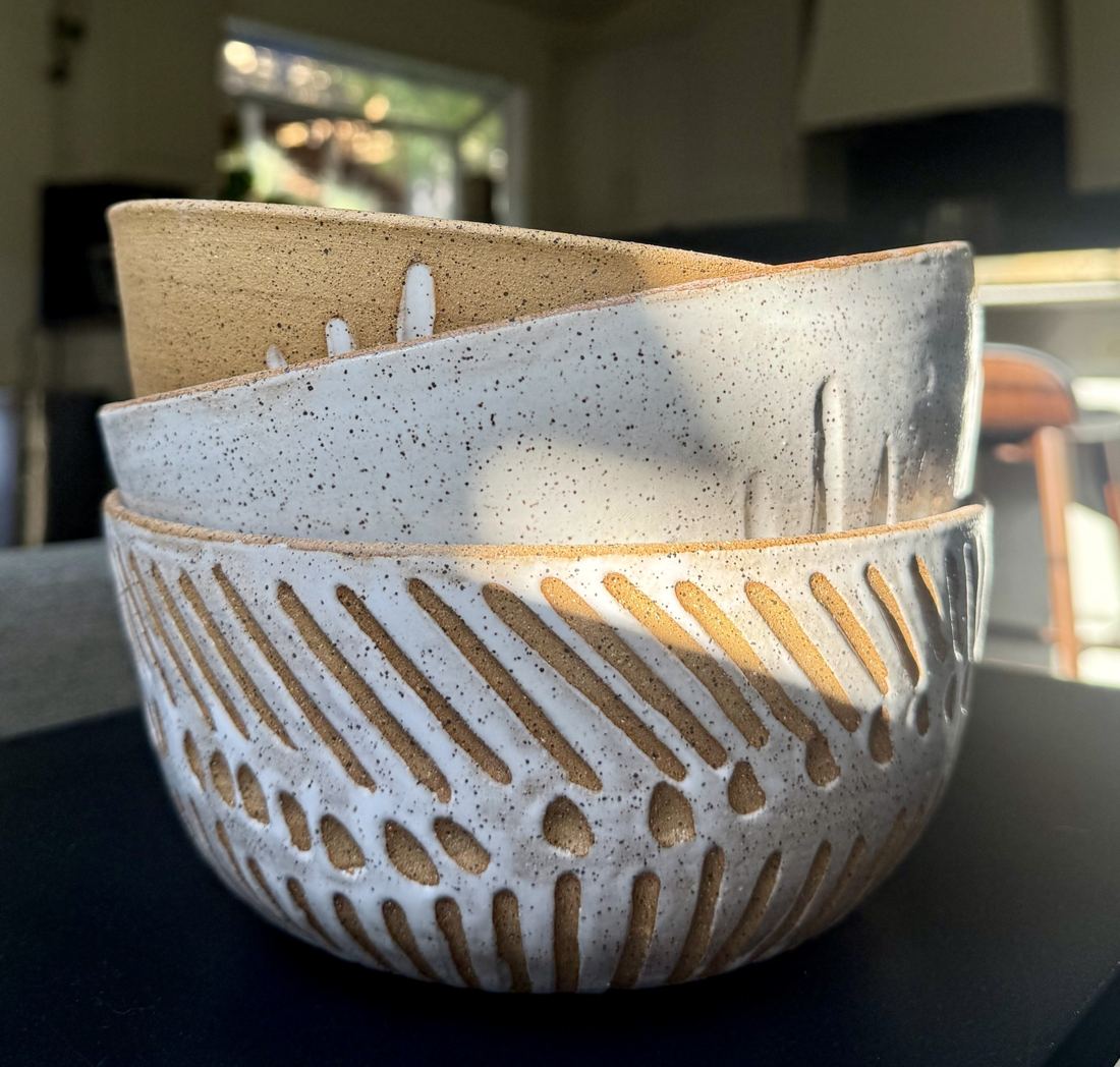 Carved bowls in white glaze and raw speckled clay