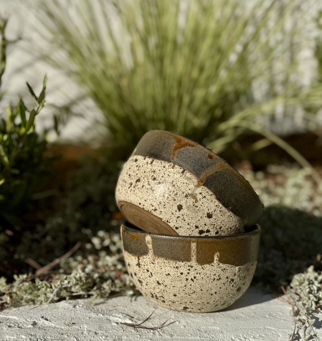 Small speckled cream bowls with a dark iron-brown rim